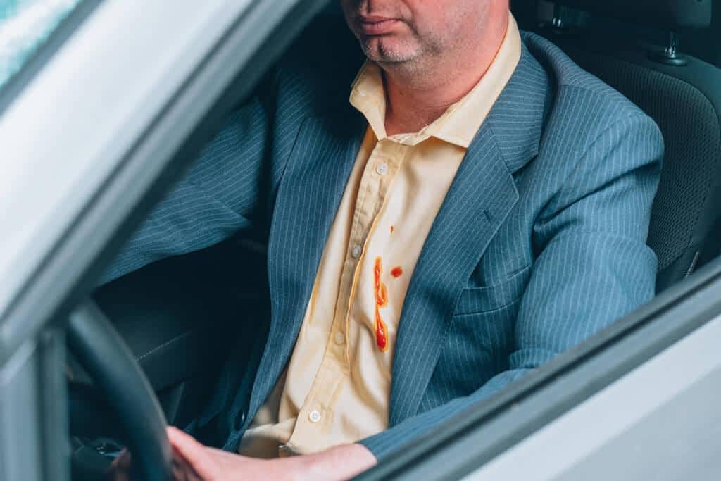 dirty tomato stains mans shirt eating while driving daily life