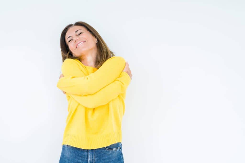 middle age woman wearing yellow sweater 1