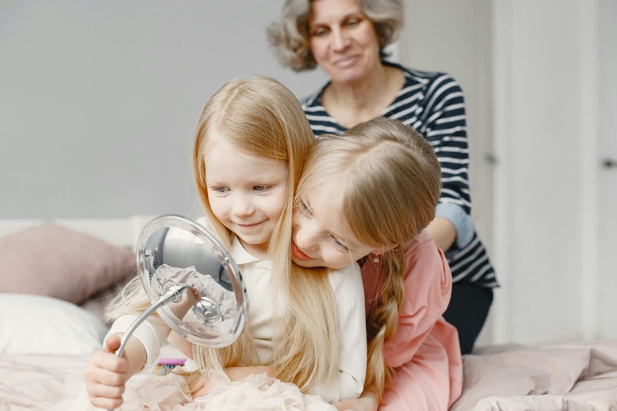 kids looking at themselves in a mirror