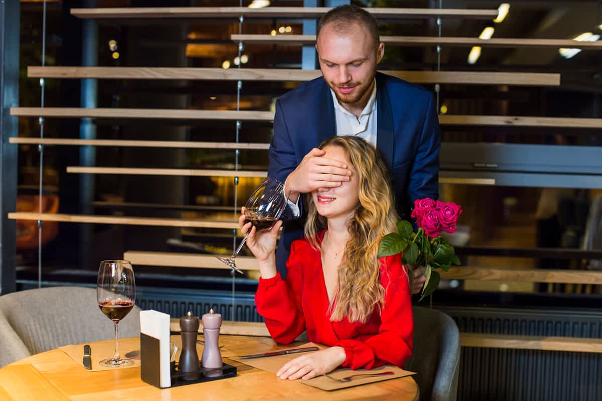 Man demonstrates Ways Rich Men Test You With Money by offering surprise roses to a woman