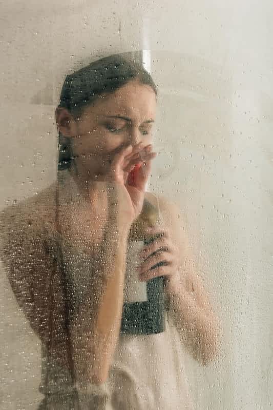 lonely depressed woman shower wine bottle home