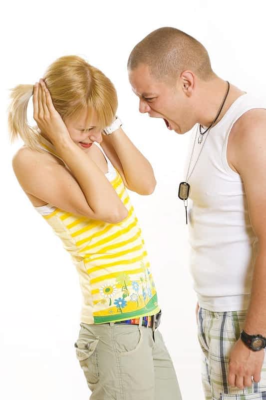 man screaming at woman domestic violence