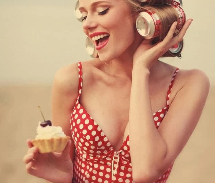 pinup model poses with cupcake as the perfect wife