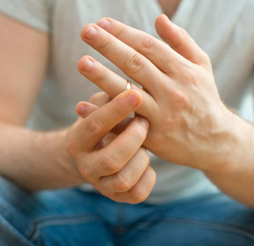man taking off wedding ring