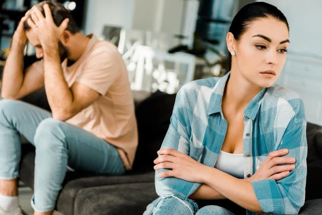Avoid These 18 Relationship Deal Breakers at All Costs 8 upset-couple-sitting-couch-arguing-home