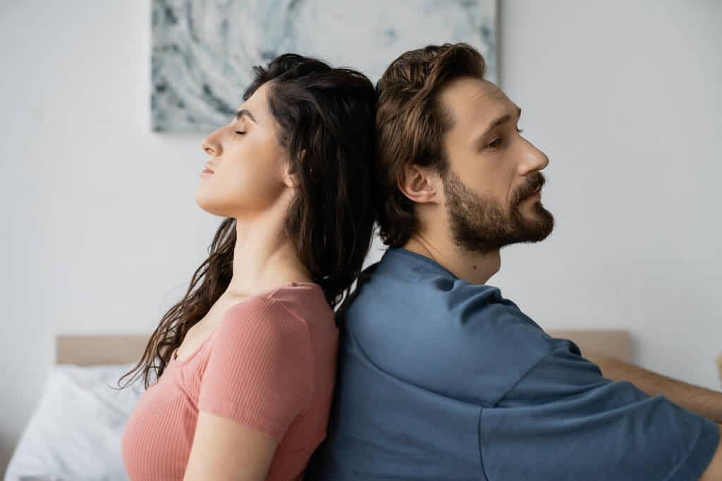 9 Clear Signs He’ll Fail As A Life Partner 4 upset bearded man sitting back back brunette girlfriend bedroom 1