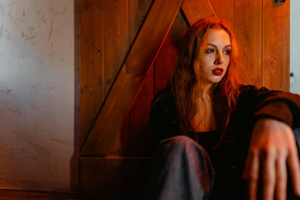 When Leaving Isn't an Option: The Secret Life of Staying 2 sad woman sitting against a door